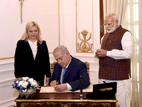 Mr-Netanyahu-signing-the-visitors-book-at-Hyderabad-House-in-New-Delhi